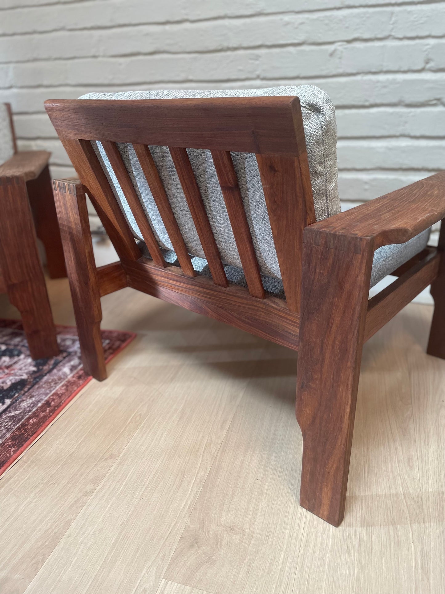 A pair of Kiaat armchairs, inspired by the iconic Kallenbach